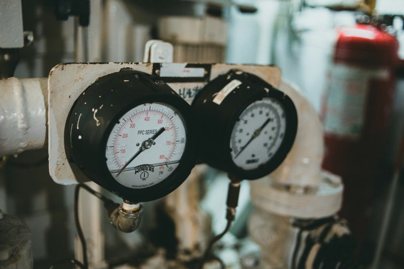 Two analog pressure gauges mounted on industrial piping