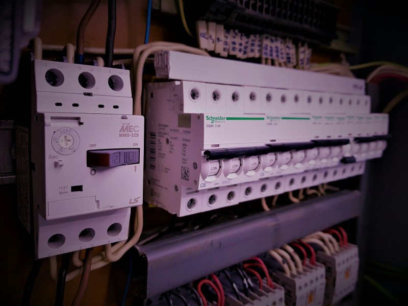 Electrical service panel with rows of circuit breakers and wiring