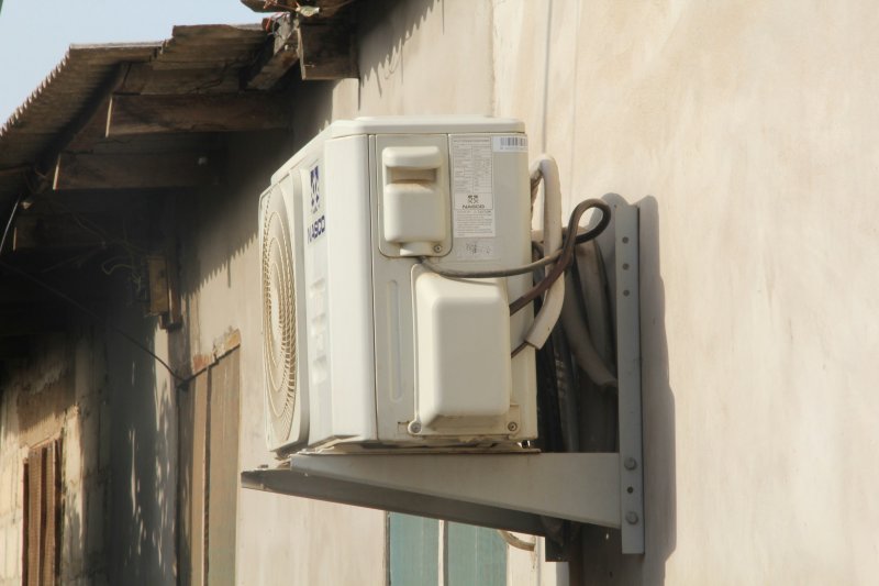 Wall-mounted ductless mini-split indoor head installed on an interior wall