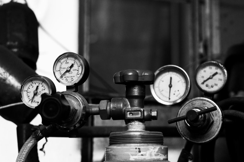 Refrigerant manifold pressure gauges and valves used during HVAC diagnostic work