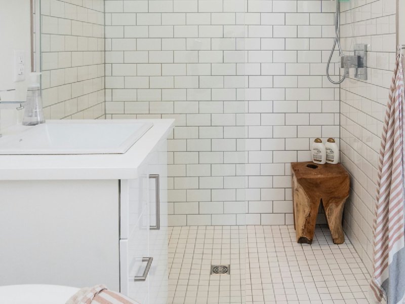 White subway tile shower with frameless glass door