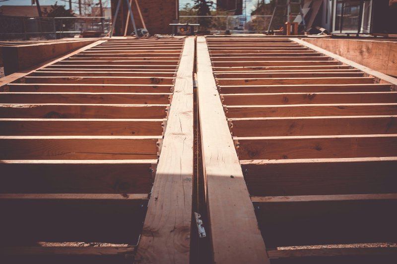 Wooden floor joists viewed from below at a residential construction site
