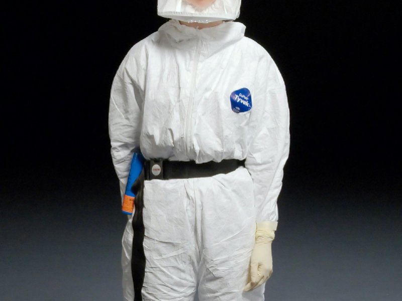 Technician in full Tyvek protective suit with hood and gloves — standard PPE for AMRT-certified mold remediation