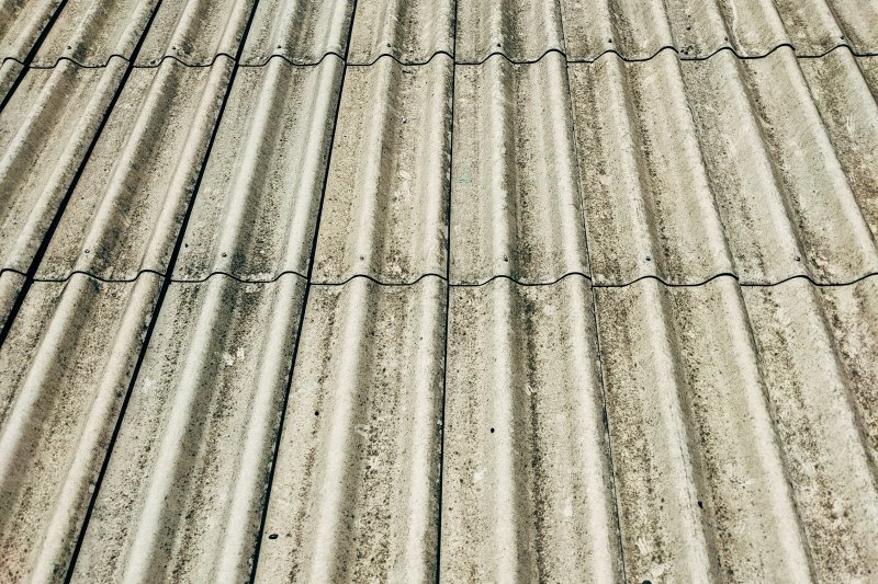 Weathered corrugated metal roof with visible seams and dirt streaks